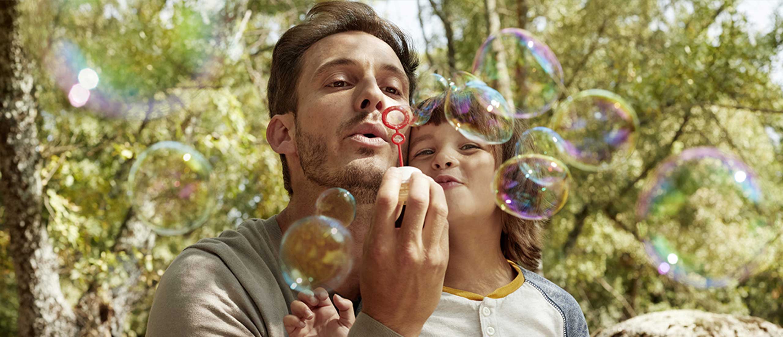 Father and Son blow bubbles together