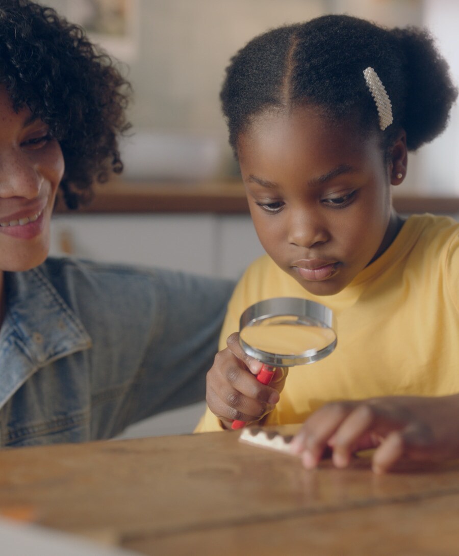 Young girl with magnifying glass