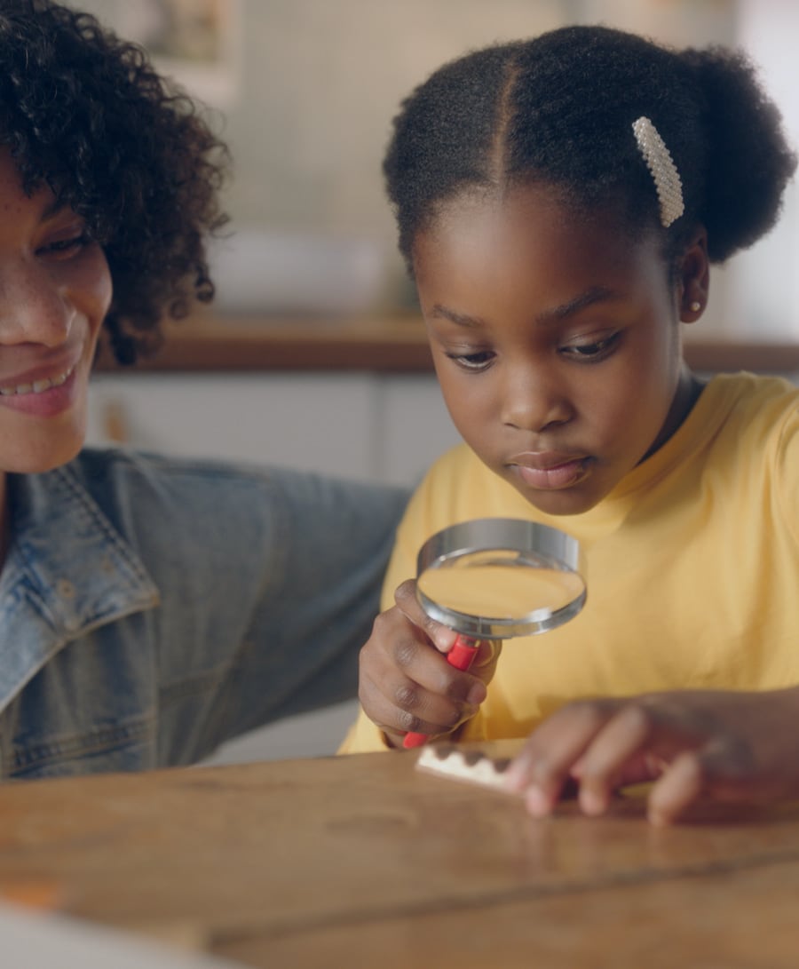 Young girl with magnifying glass