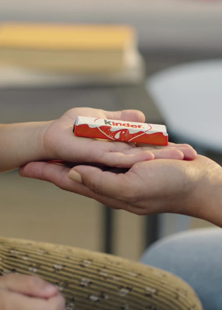 Father and daughter eat Kinder together
